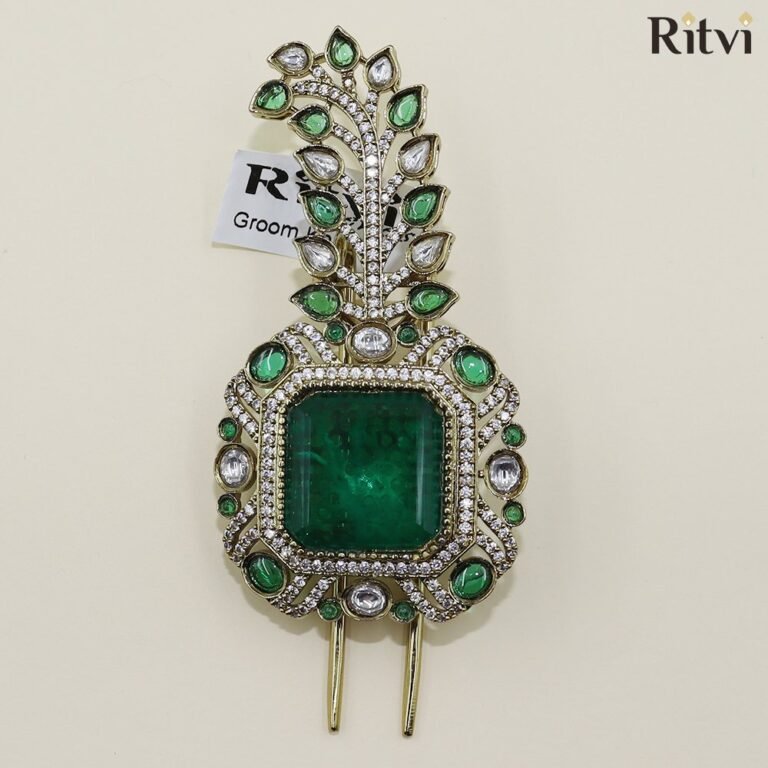 Green Kundan groom kalgi with emerald centre stone, sparkling crystals and intricate gold leaf detailing for Indian wedding
