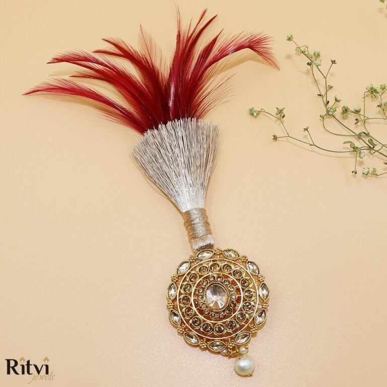 Red feather groom kalgi with intricate gold Kundan detailing, sparkling stones and pearl drop for Indian wedding