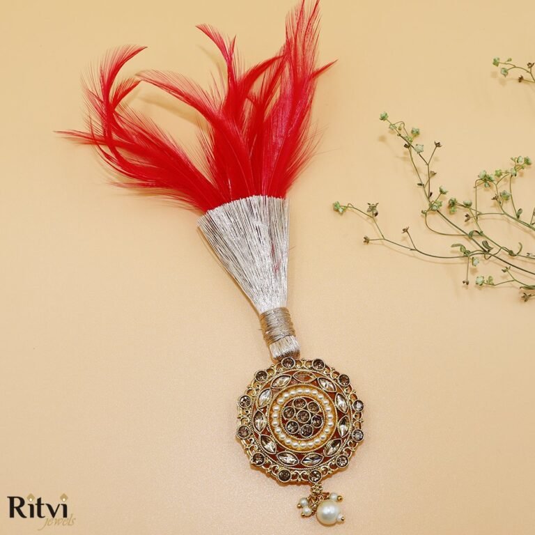 Red feather groom kalgi with intricate gold Kundan detailing, sparkling stones and pearl drop for Indian wedding