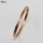 Gold-plated swirl pattern kada bracelet for women by Ritvi Jewels