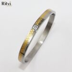Two-tone gold and silver kada bracelet with stone accent by Ritvi Jewels