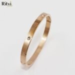Gold-plated Om symbol kada bracelet with crystal accents for women by Ritvi Jewels