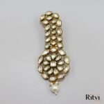 Elegant Kundan groom kalgi with sparkling white stones, intricate gold detailing, floral design and pearl drop for Indian wedding