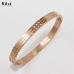 Rose gold-toned bracelet with sleek triple-line design and sparkling crystal detailing