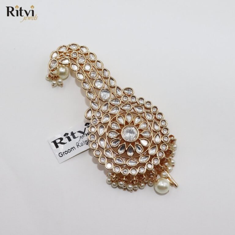 Exquisite Kundan groom kalgi with intricate gold detailing, sparkling white stones, floral design and pearl drops for Indian wedding