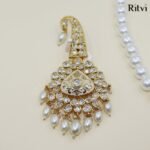 Elegant Kundan groom kalgi with sparkling white stones, intricate gold detailing and pearl drops for Indian wedding