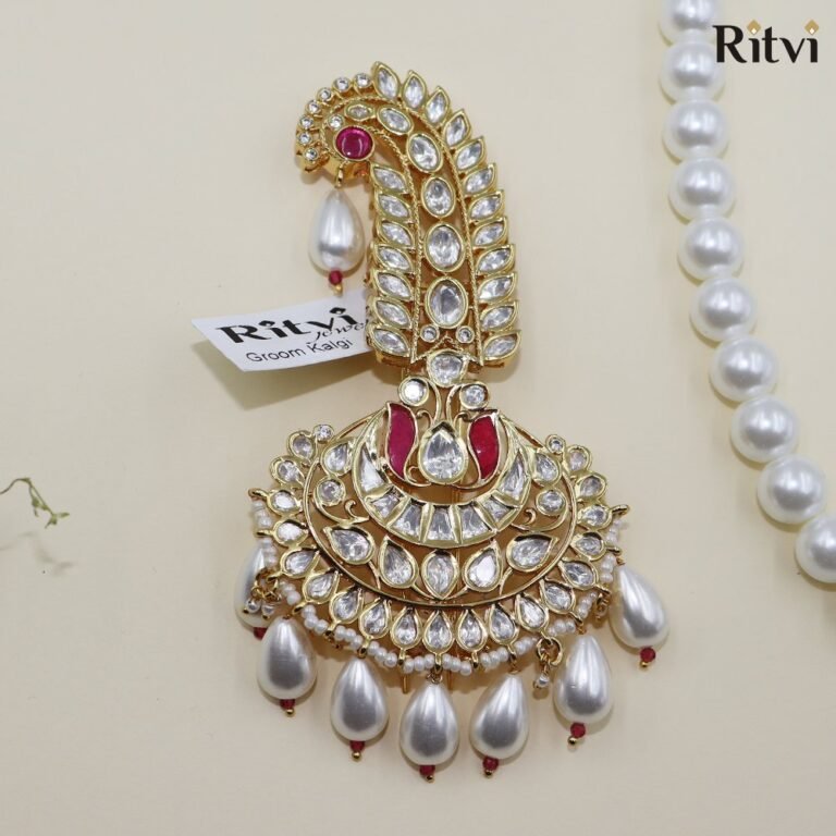 Gold-toned Kundan bridal chura accessory with red stones, sparkling white crystals, pearls, and elegant drop embellishments