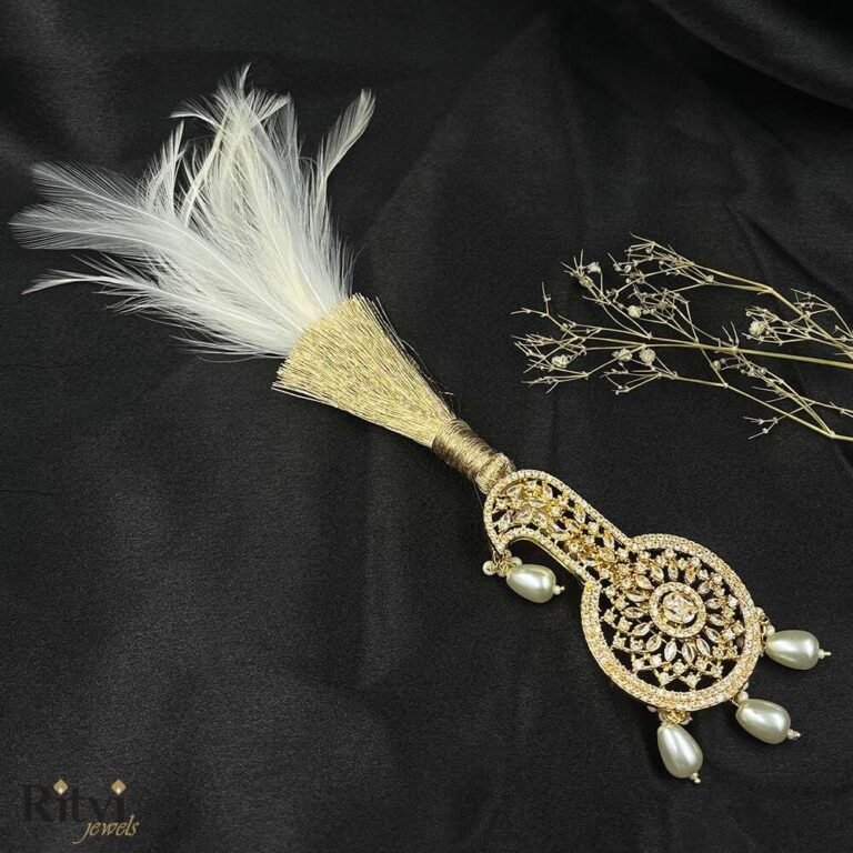 White feather kundan kalgi with pearl drops and intricate gold detailing for groom wedding accessories