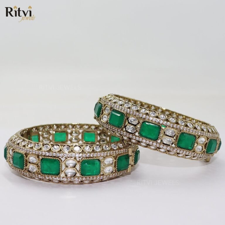 Emerald green bridal bangles with Kundan-style detailing, sparkling stones, and intricate gold-toned craftsmanship