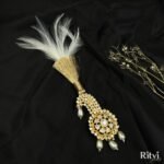 White feather kundan kalgi with pearl drops and intricate gold detailing for groom wedding accessories