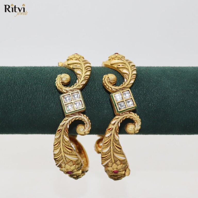 Gold-toned traditional bangles with intricate leaf-inspired detailing and sparkling square-cut stones