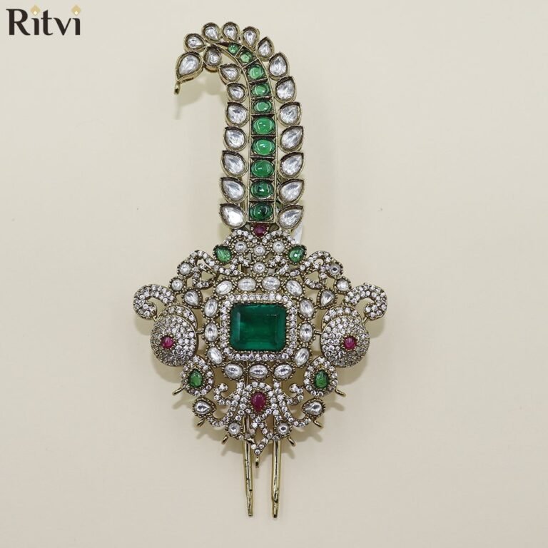 Luxury green Kundan groom kalgi with emerald centre stone, sparkling crystals and intricate peacock-inspired gold detailing for Indian wedding