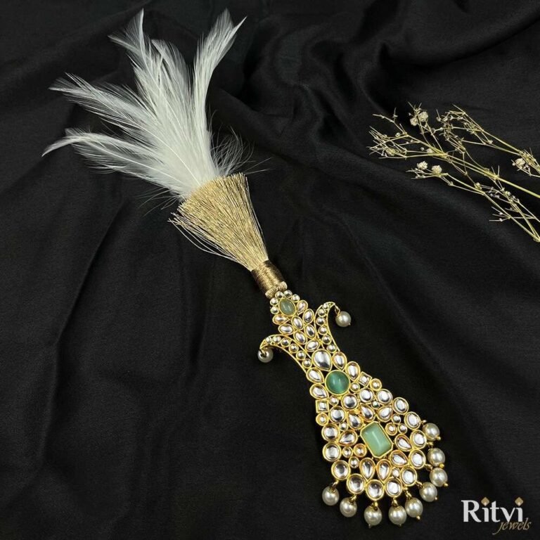 Royal green Kundan groom kalgi with white feathers, sparkling stones, gold detailing and pearl drops for Indian wedding
