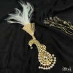White feather groom kalgi with intricate Kundan detailing, sparkling stones and pearl fringe for Indian wedding