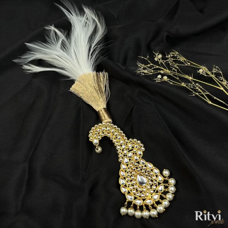 White feather groom kalgi with intricate Kundan detailing, sparkling stones and pearl fringe for Indian wedding