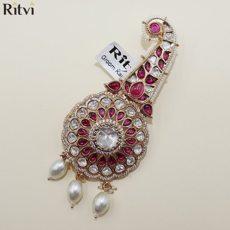 Gold-toned bridal chura accessory with ruby-red stones, Kundan-style detailing, pearl accents, and hanging pearl drops
