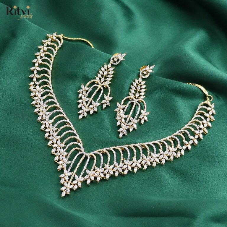 Elegant American Diamond V-shape necklace set with sparkling floral design and matching earrings, perfect for bridal, wedding, party, and festive wear.