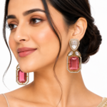 Kaisha gold-plated pink crystal drop earrings with emerald-cut stones, pear-shaped crystals and zircon detailing, elegant statement earrings for weddings, parties and festive wear.
