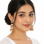 Panchhi gold-plated pearl jhumka earrings with ruby pink and emerald green stones, traditional bridal earrings for weddings, festive and ethnic wear.